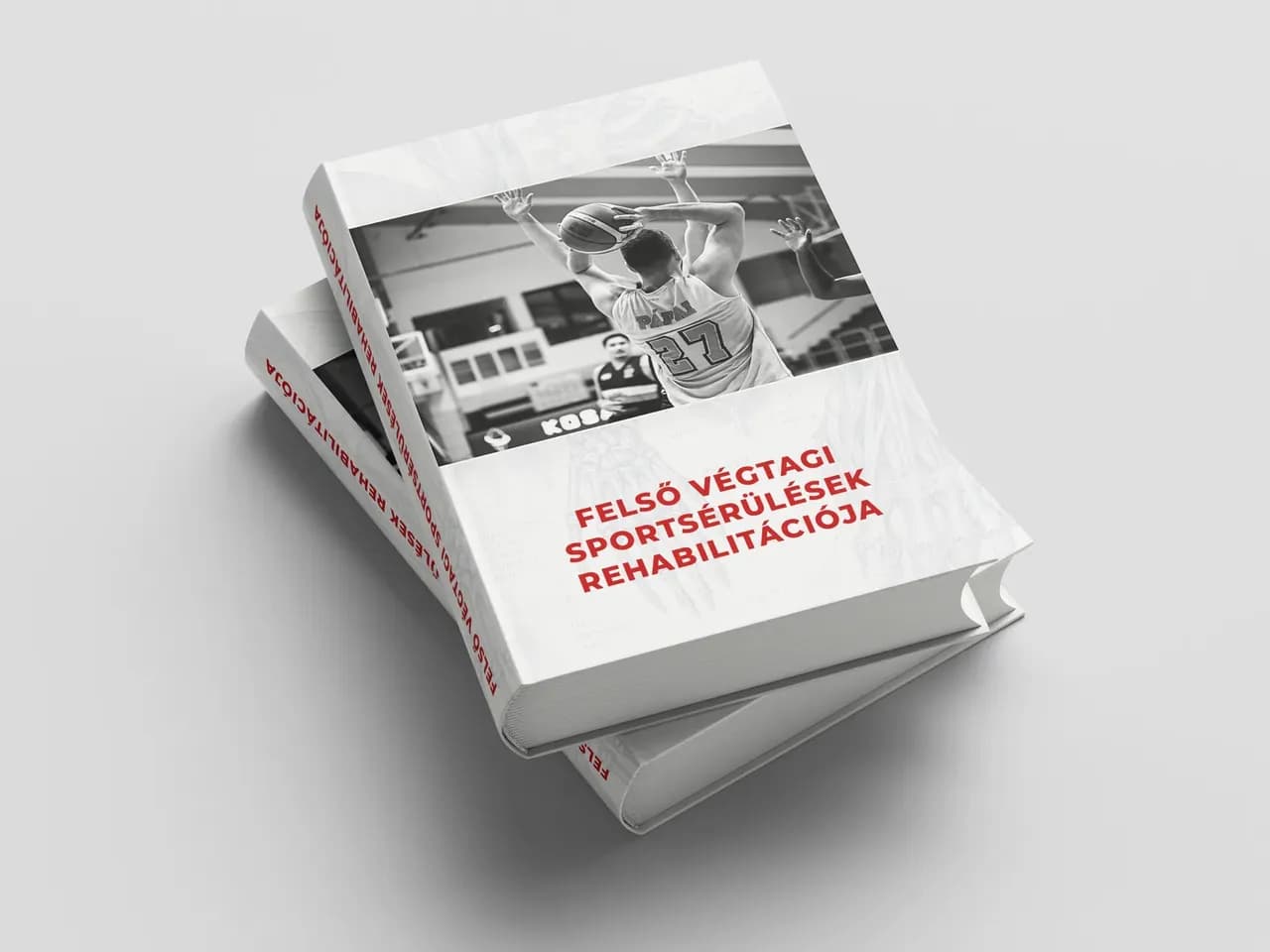 A Felső végtagi sportsérülések rehabilitációja című szakkönyv két példánya egymásra fektetve.